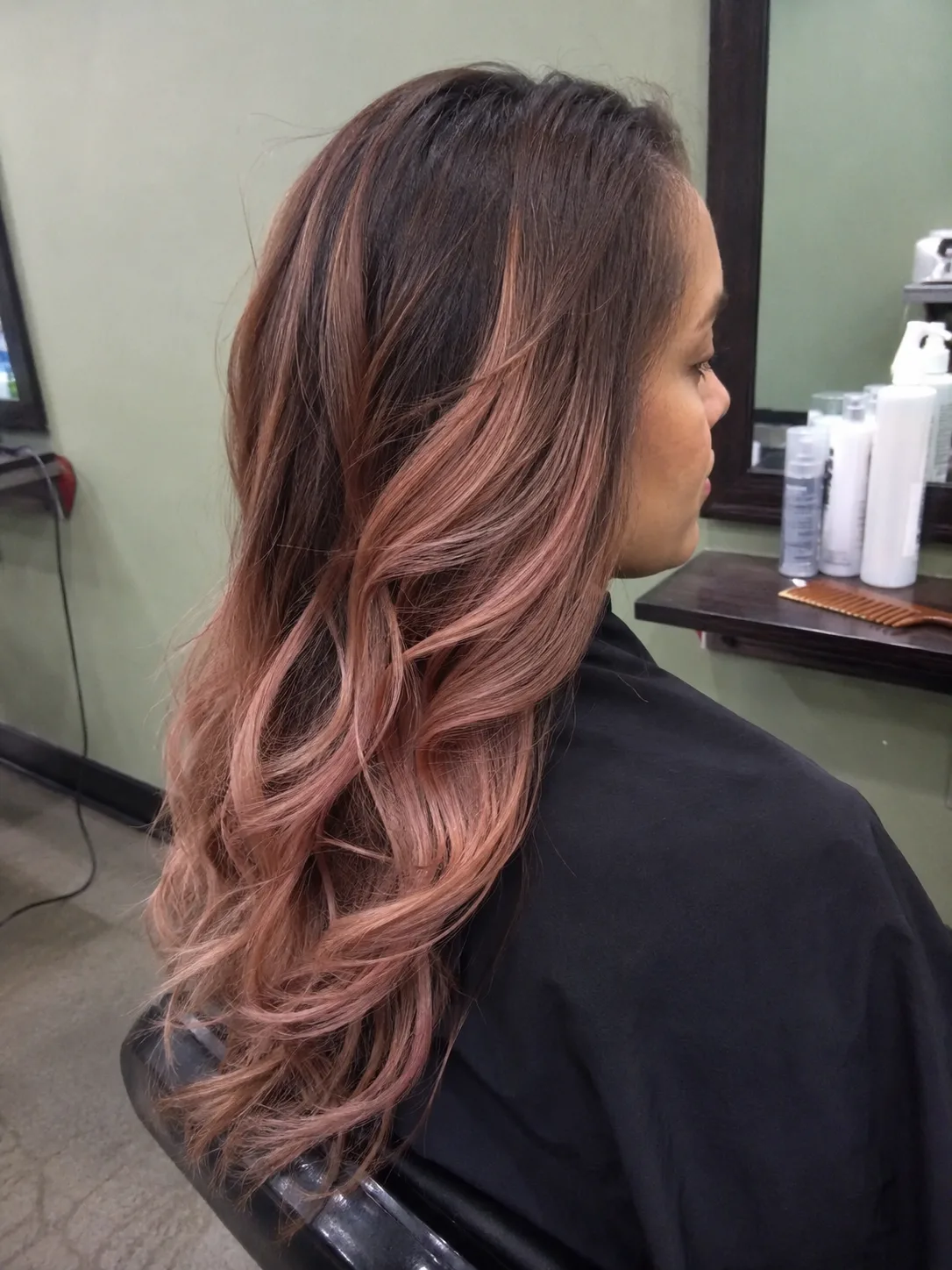 Magenta pink streaks on jet black curly hair