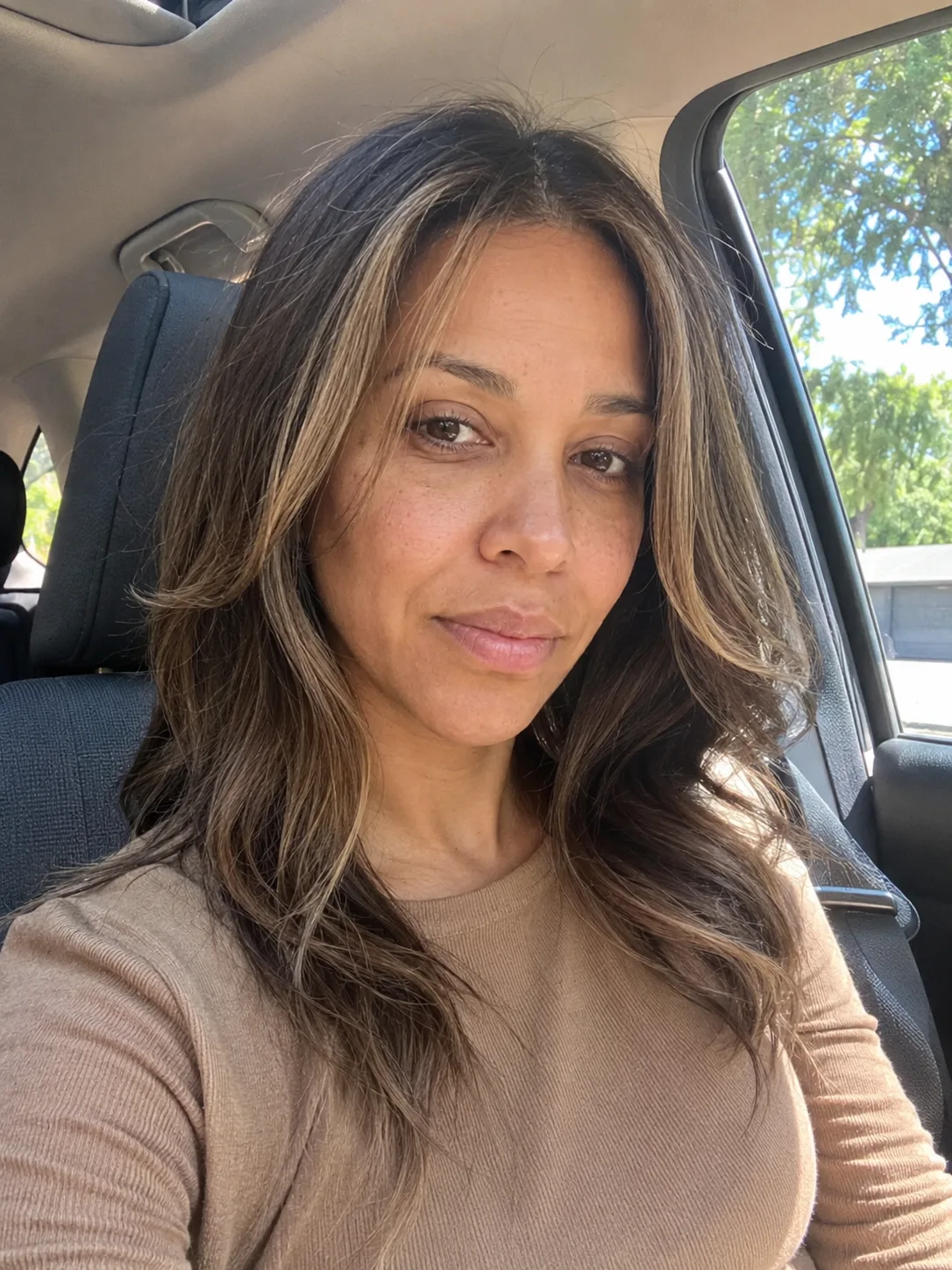 Copper hair color with soft strawberry tones and long straight hair with subtle waves