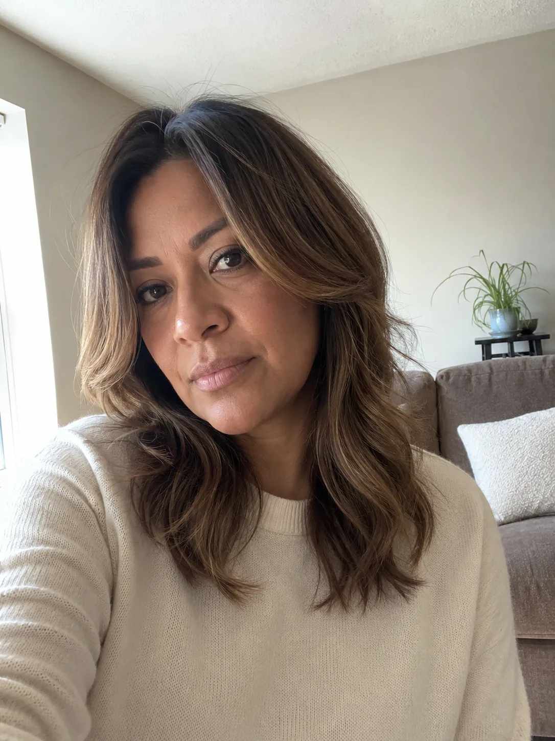 Rustic copper hair color with earthy brown undertones and medium wavy lob haircut