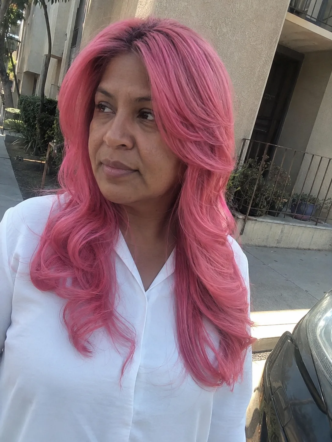 Vibrant pink highlights on long straight brunette hair