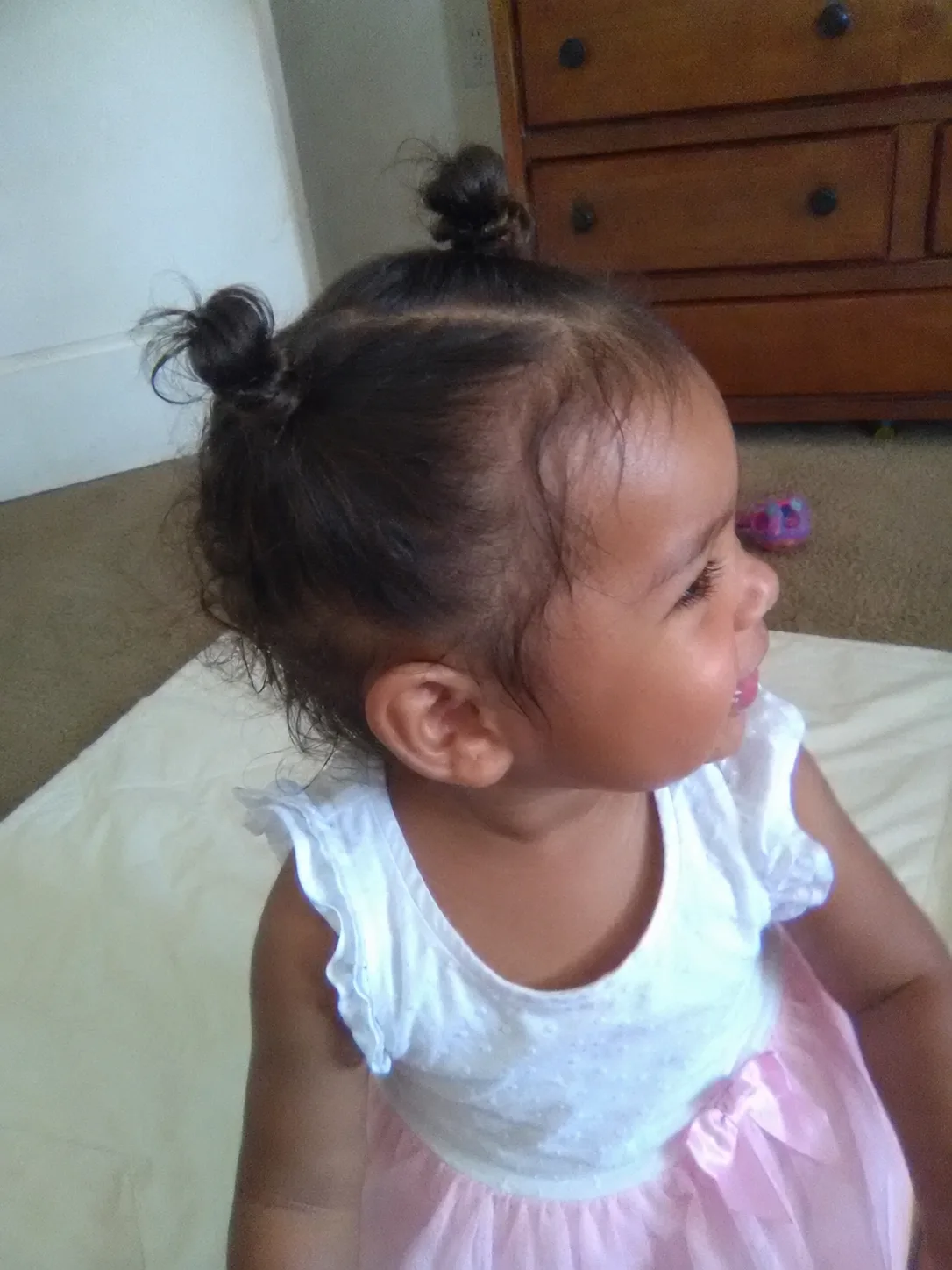 A beautifully styled and groomed toddler showing soft, natural wispy strands on a well-maintained crown.