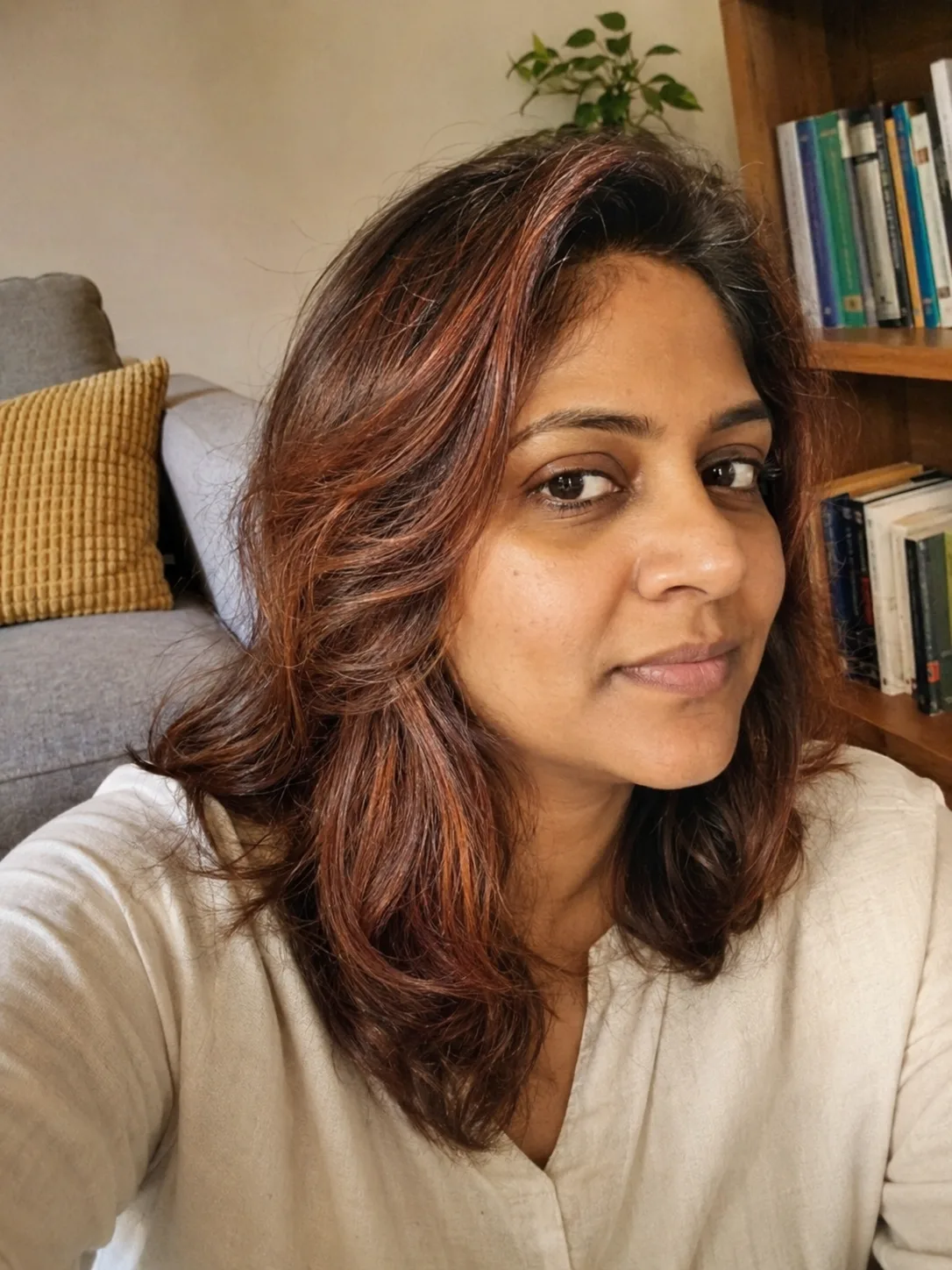 Shoulder-length brunette layers with soft face-framing highlights