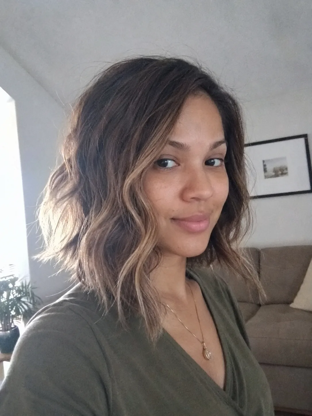 Straight shoulder-length brunette bob with subtle gray strands