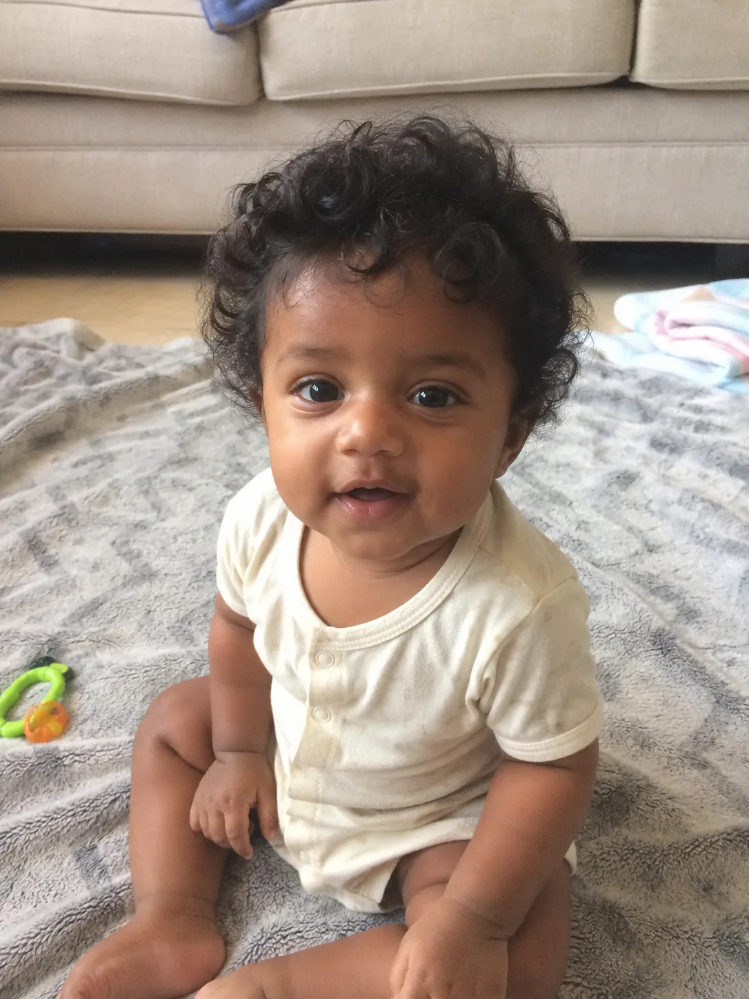 A close-up view of a clean, gentle part on an infant's very fine blonde hair