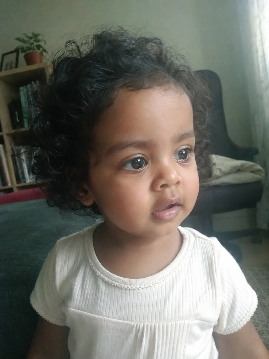 A close-up view of fine baby hair showing product residue sitting on top of the hair shaft