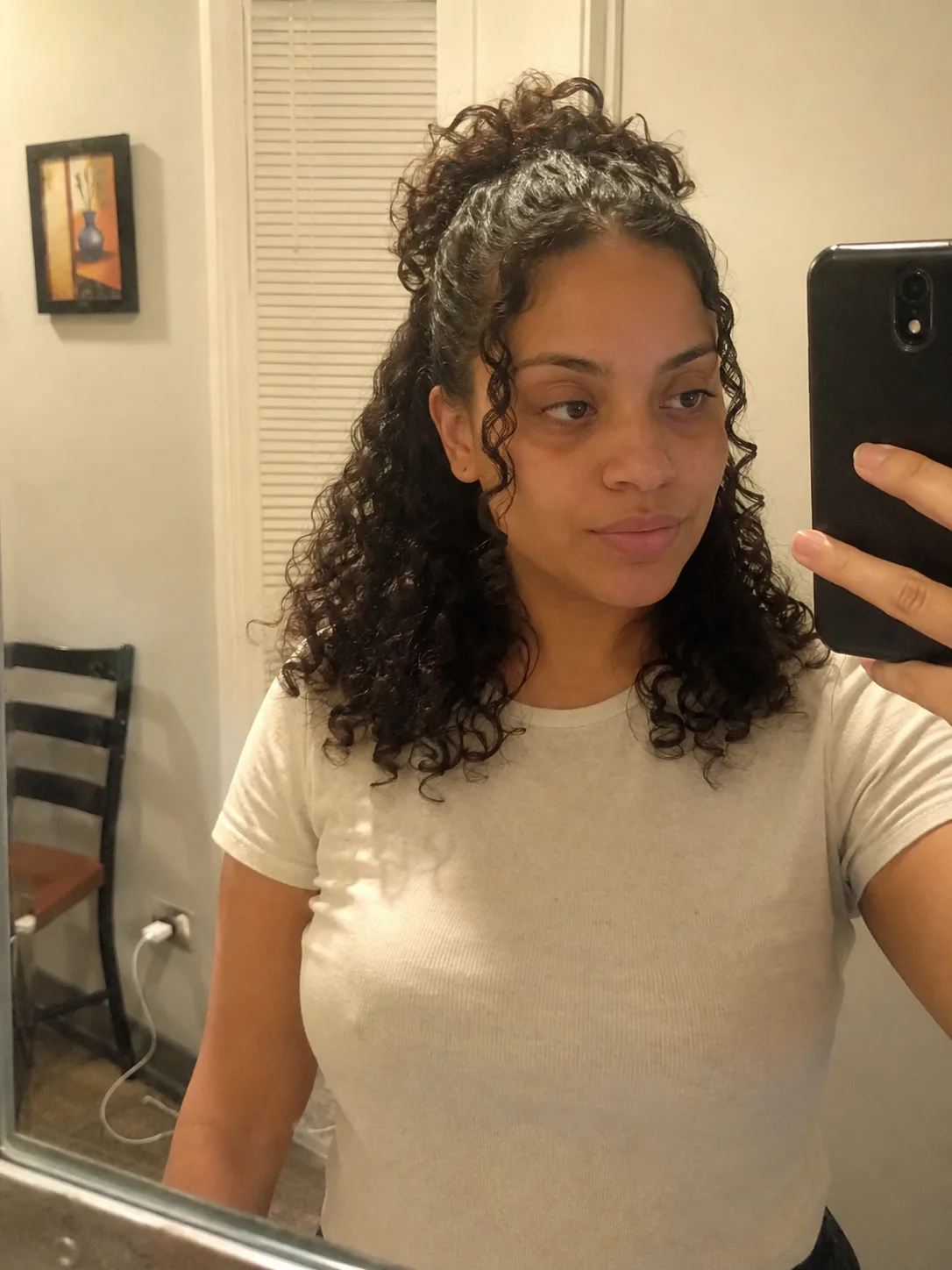 A high curly puff showing the natural shrinkage and volume of type 4 hair