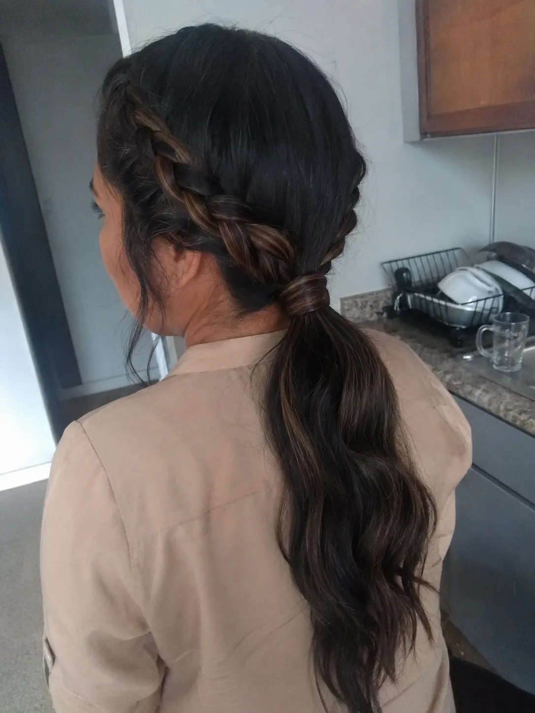 A loose, asymmetrical side braid with face-framing tendrils left free for an undone, effortless look