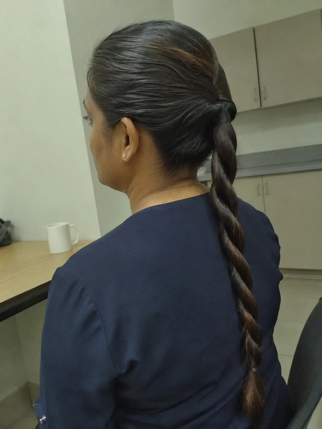 A loose, curly side-swept ponytail embracing natural texture