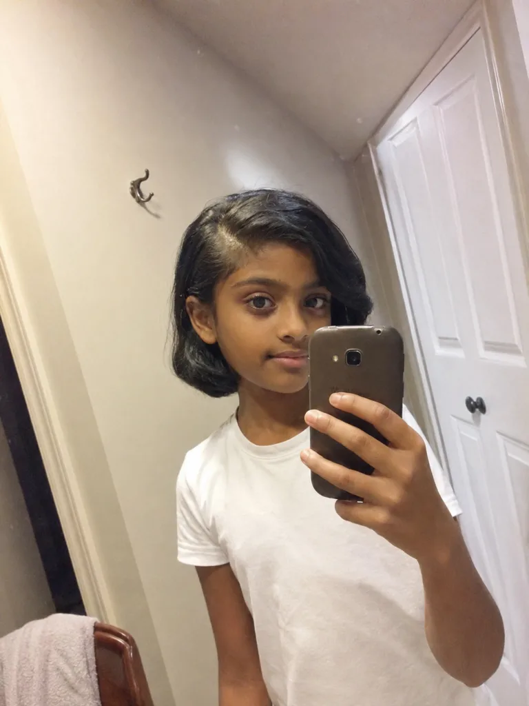 A modern and lightweight short haircut on a young child showing clean texturing.