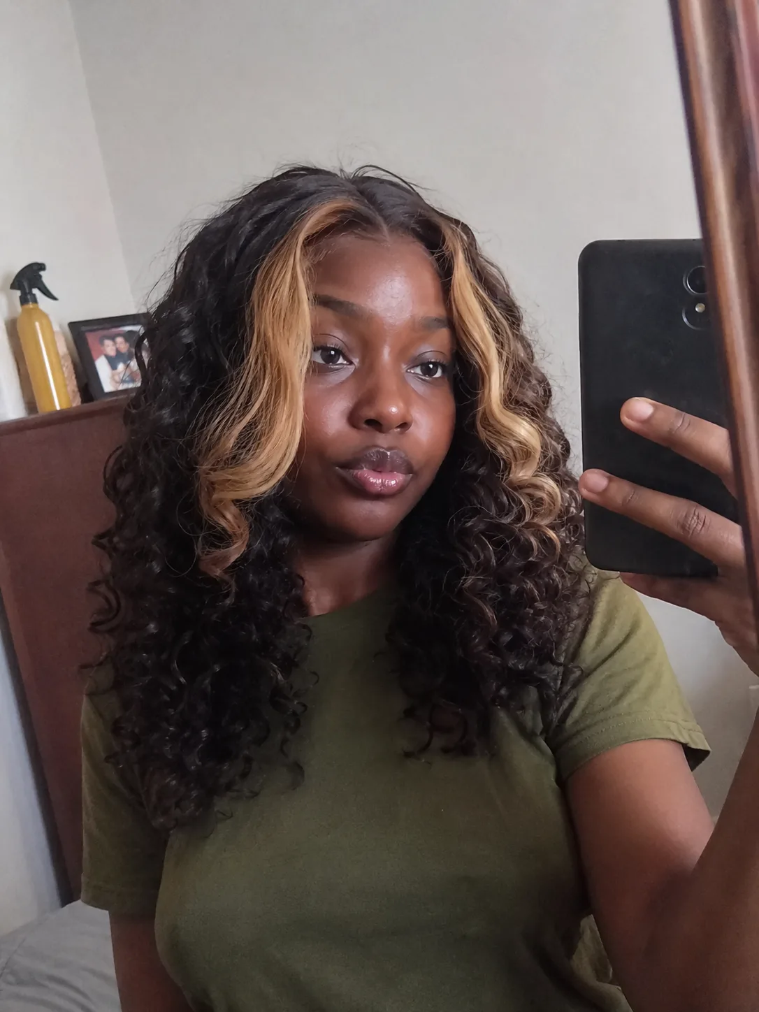 A portrait of a woman looking to the side, showcasing voluminous wavy long hair dyed a rich dark chocolate brown with deep burgundy and plum undertones