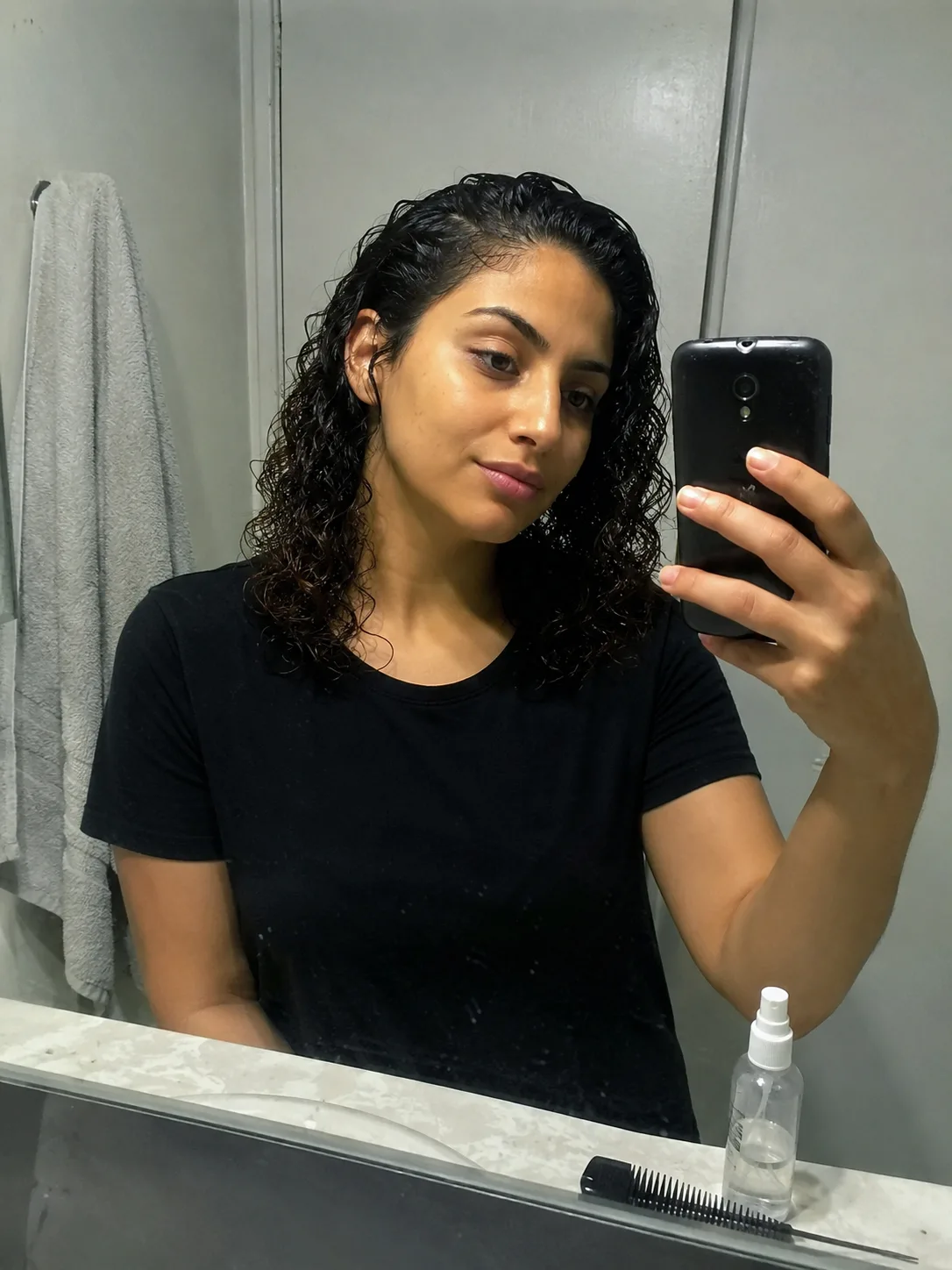 A shaggy, curly cut with soft bangs, highlighting the natural shape of the curls
