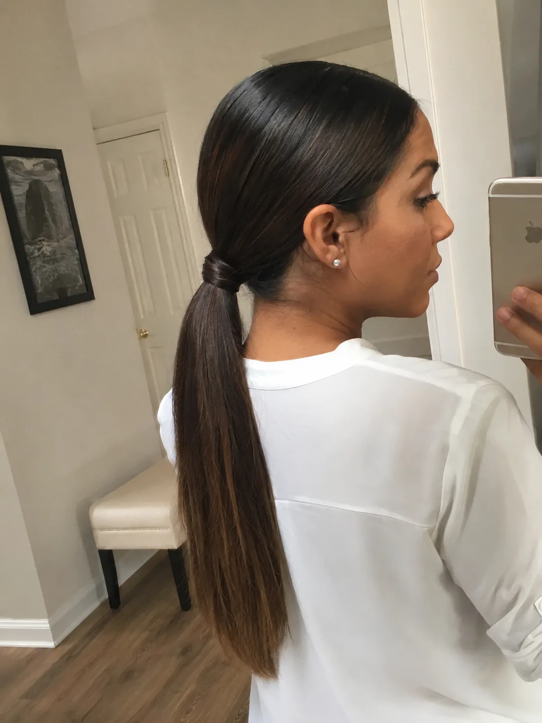 A side-profile selfie of a woman with a very high, sleek, straight ponytail with laid edges