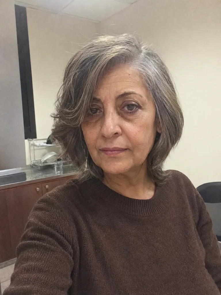 A sophisticated and elegant short haircut for women over 60 showcasing healthy volume and structural definition for fine hair.