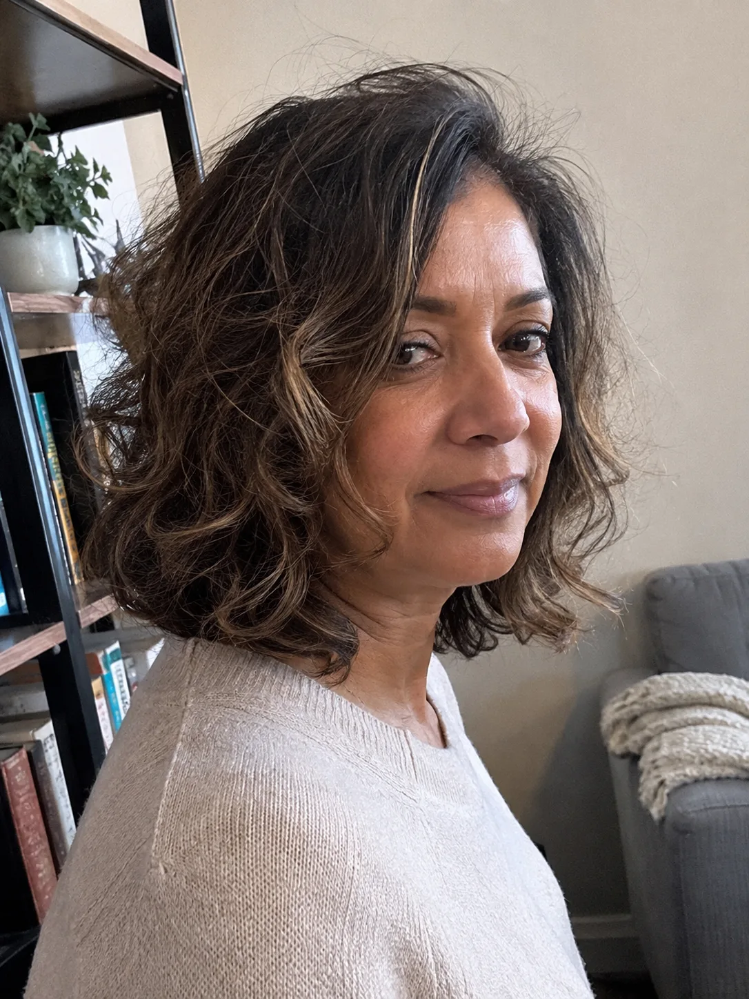 A textured, collarbone-length lob (long bob) with defined, layered waves and a soft side part that embraces natural volume