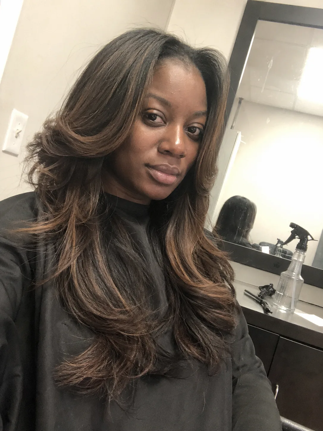 Long straight brunette hair with side-swept face-framing layers