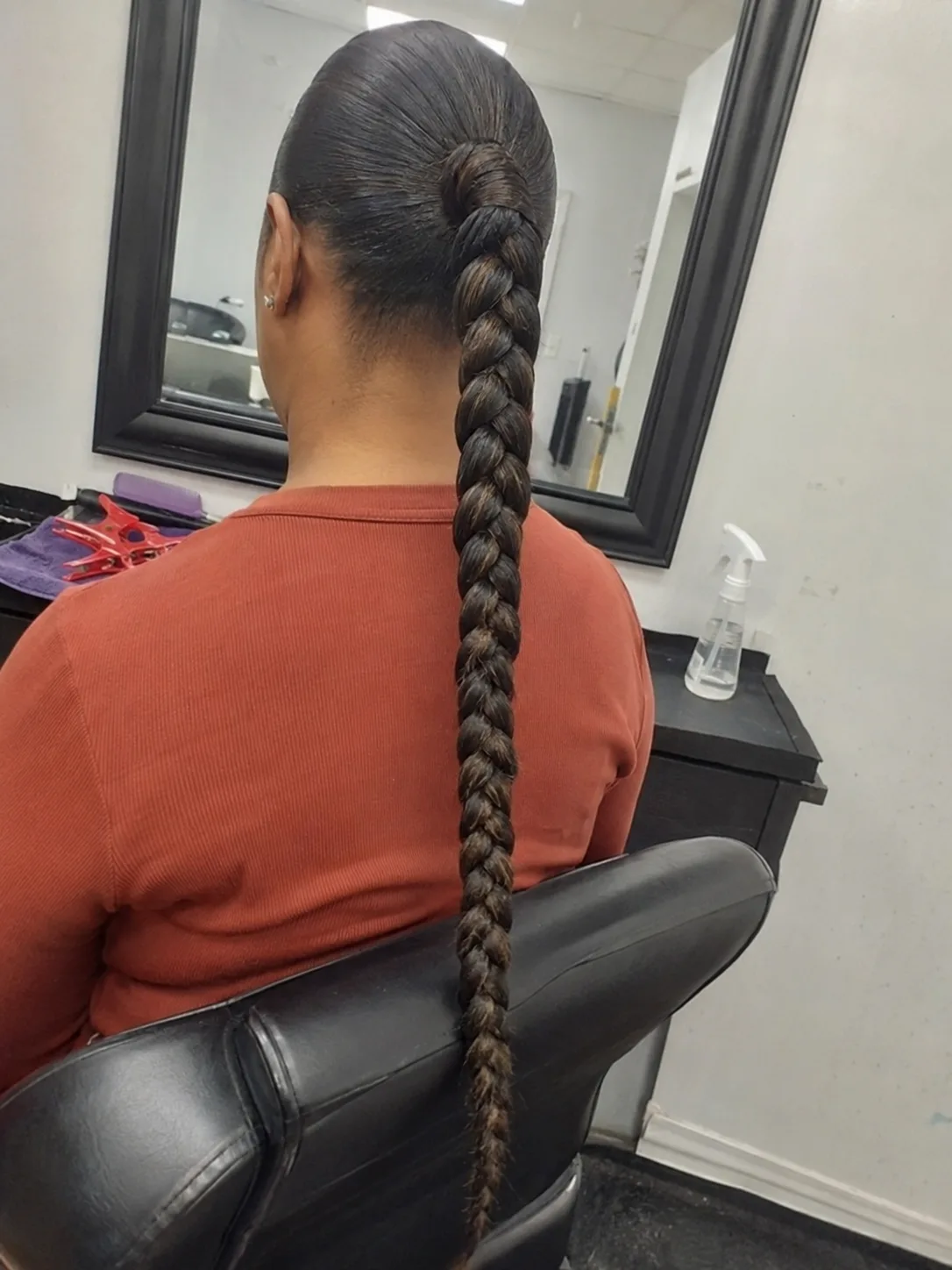 A woman seen from behind, sporting a bubble ponytail hairstyle with multiple hair ties