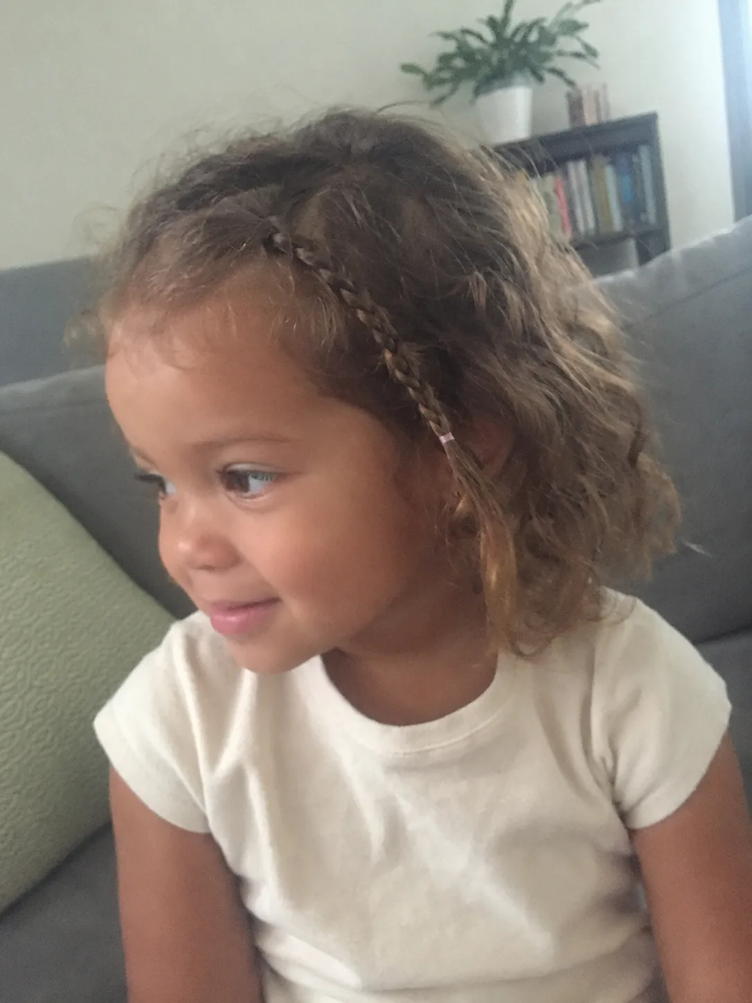 Applying a light-hold, weightless conditioning cream to fine toddler strands