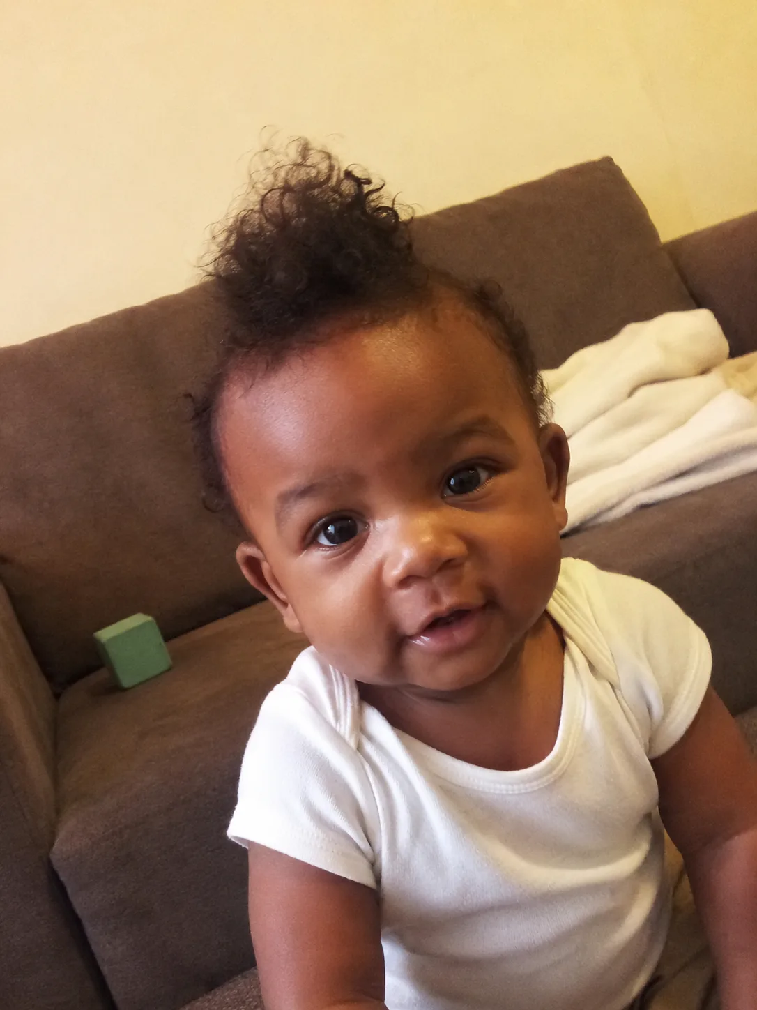 Gentle curl pattern appearing at the root and nape of a one-year-old child
