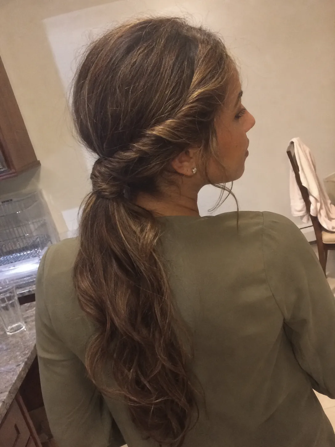 Balanced low chignon split into internal supportive sections on deep black dense hair