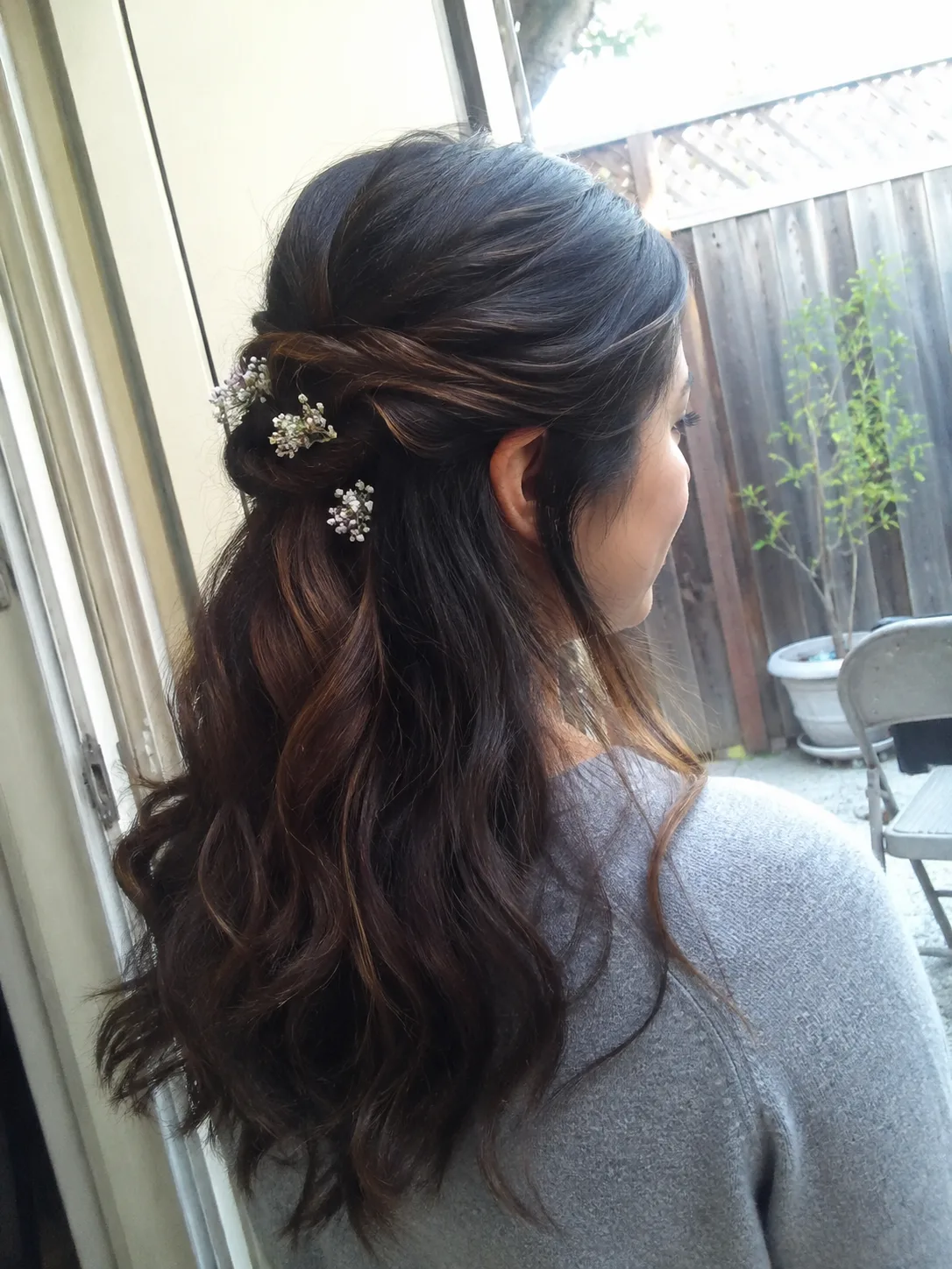 Bridesmaid hairstyles half up half down with pearl pins and curled hair