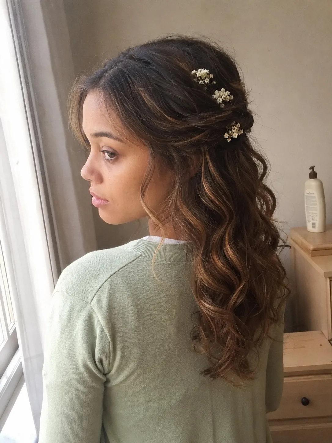 Bridesmaid hairstyles half up half down with ribbon braid and curly texture.