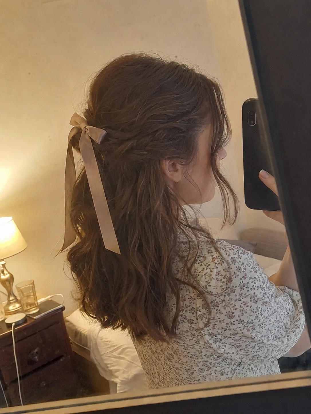 Bridesmaid hairstyles half up half down with sleek twist back and curled ends