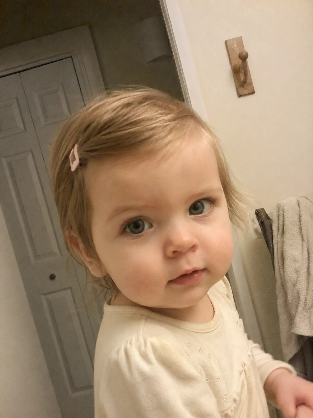 Clean hair parting lines achieved gently on a moving toddler during a styling session