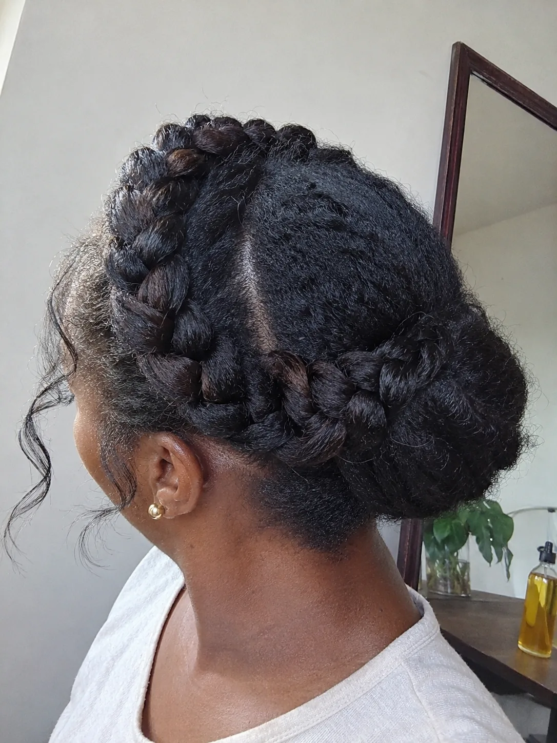 Cleanly divided low twist updo highlighting structural support pins at the base of the neck