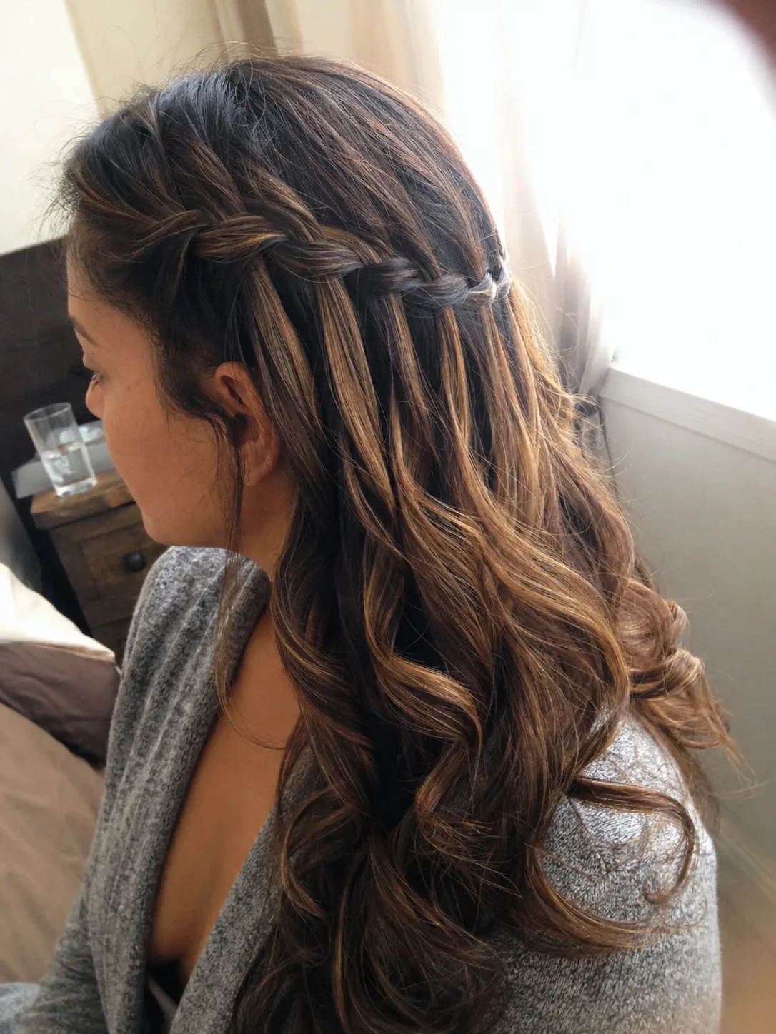 Close up view of individual strands being pulled out gently using a tail comb for a textured finish