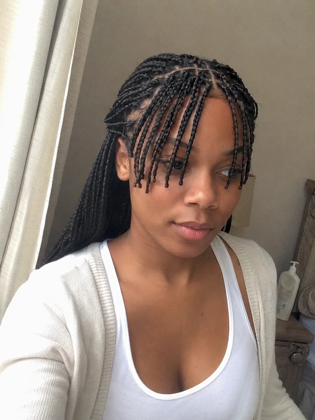 Cornrow braids gathered into a low bun for a neat summer protective style