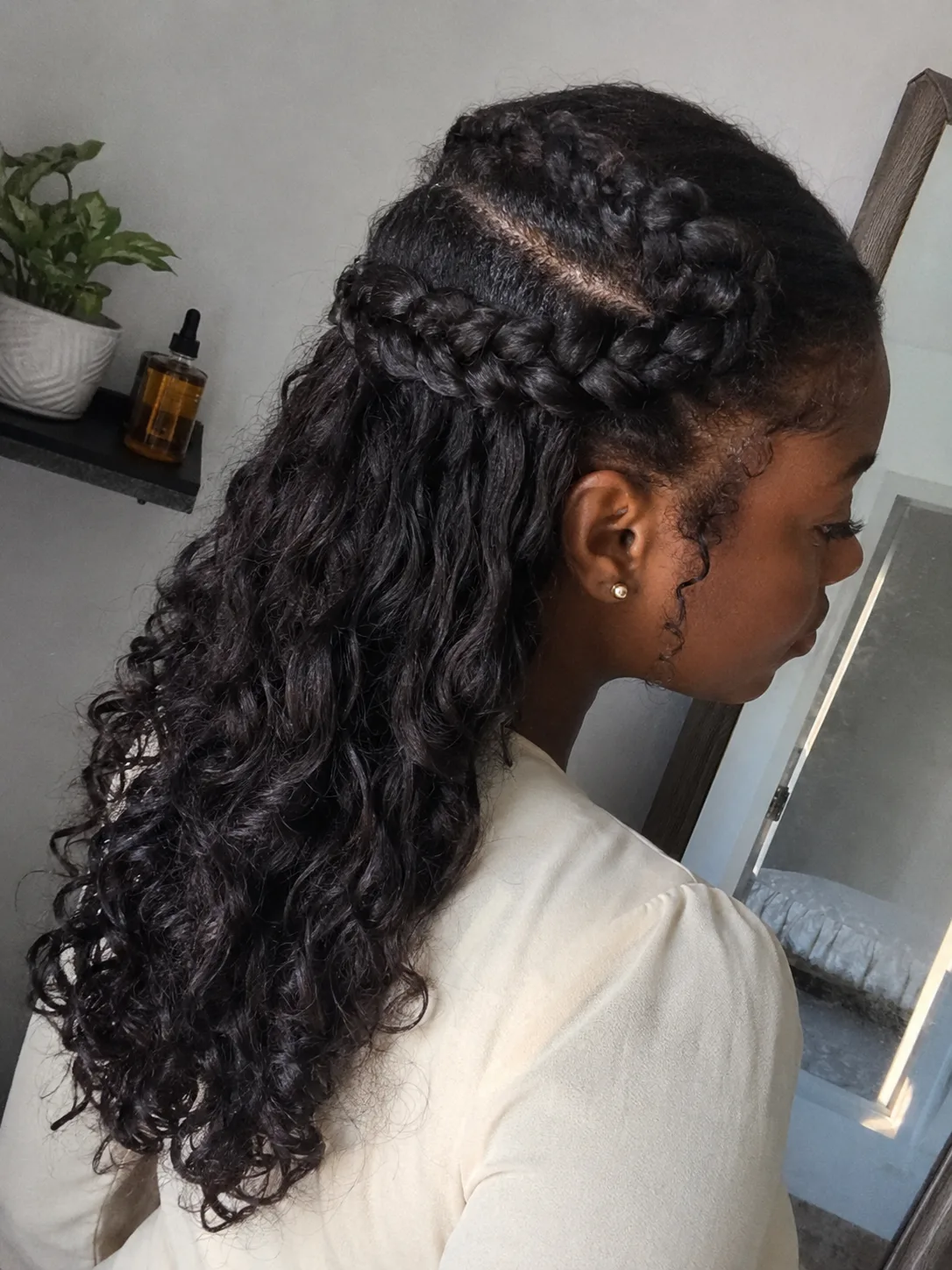 Detailed French braid weaving smoothly into a half-up anchor on ash-blonde hair