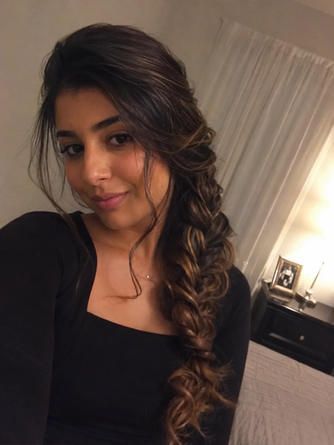 Easy half-up twisted prom hairstyle with loose beach waves and soft highlights