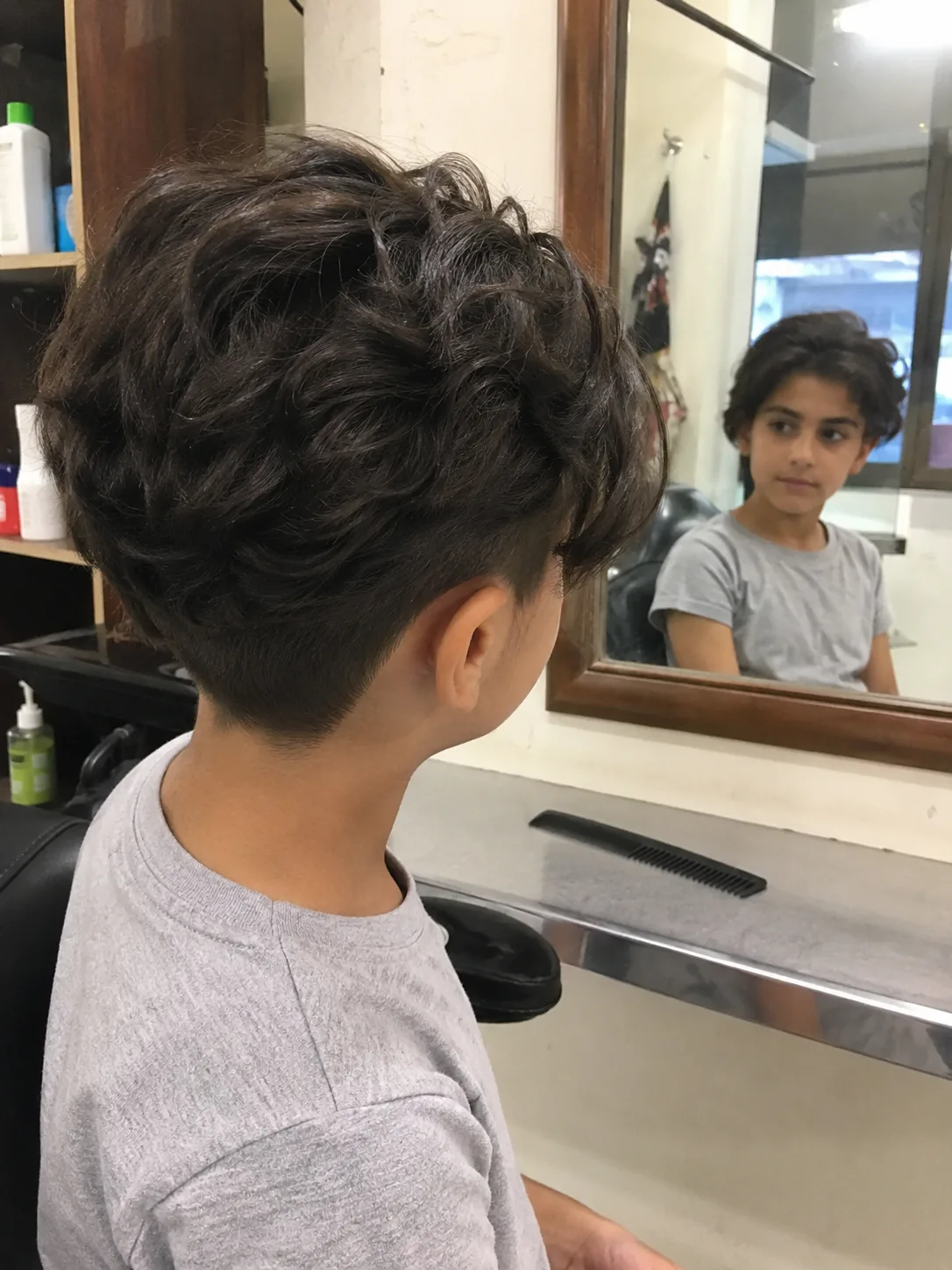 Evaluating ear placement symmetry and front proportions of a child's short cut