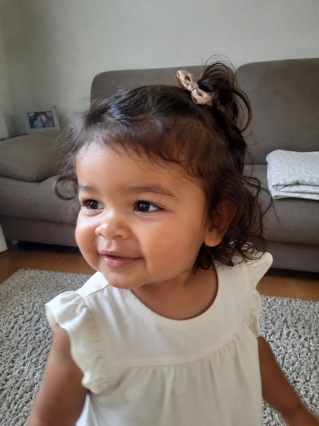 Finger detangling method performed gently on a toddler's textured curls