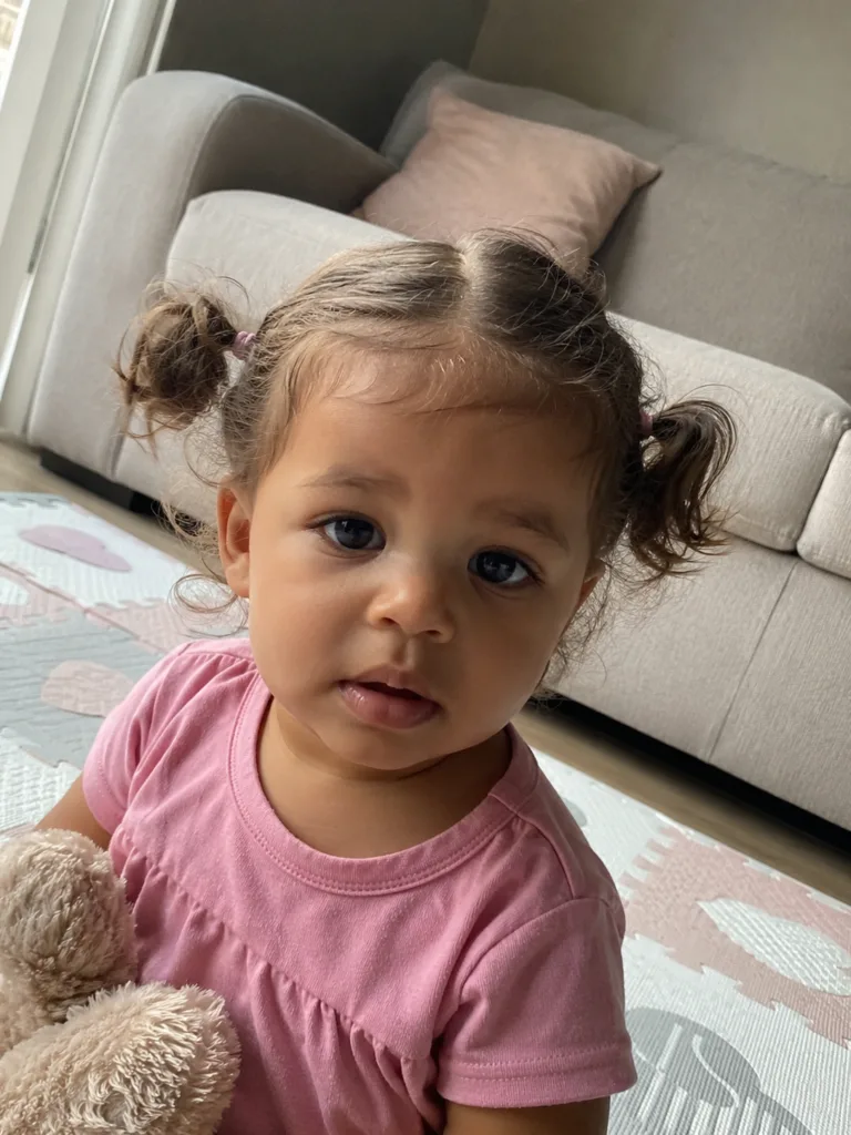 Gentle styling on a baby with soft, fine wispy hair displaying natural texture.