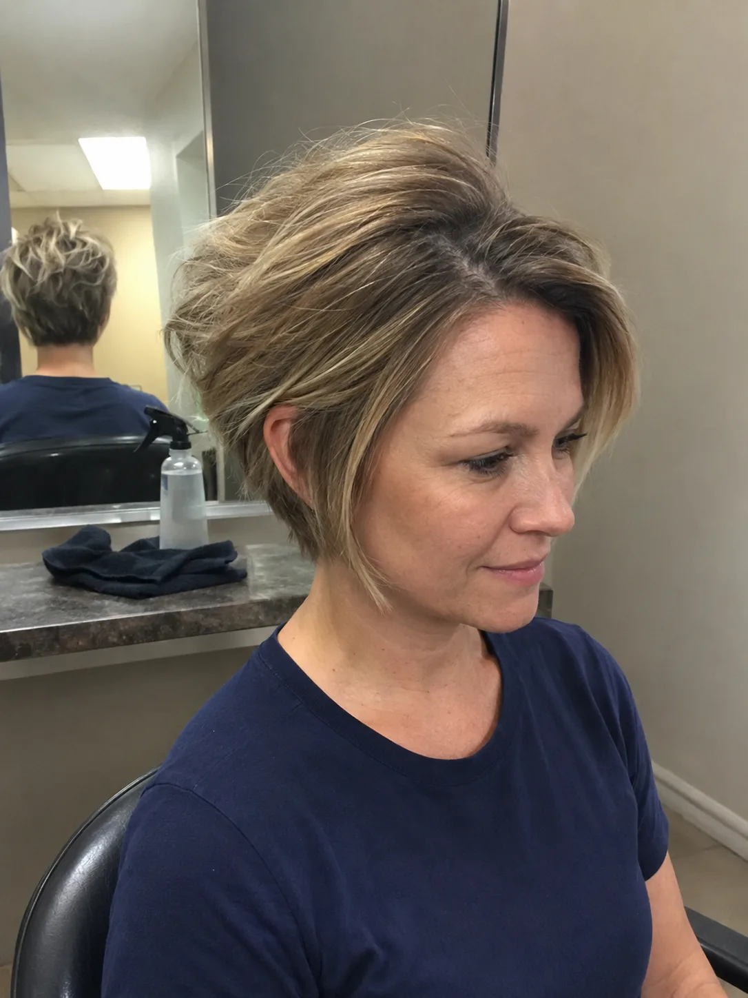 Half up blowout hairstyle with loose layered movement and soft face pieces.