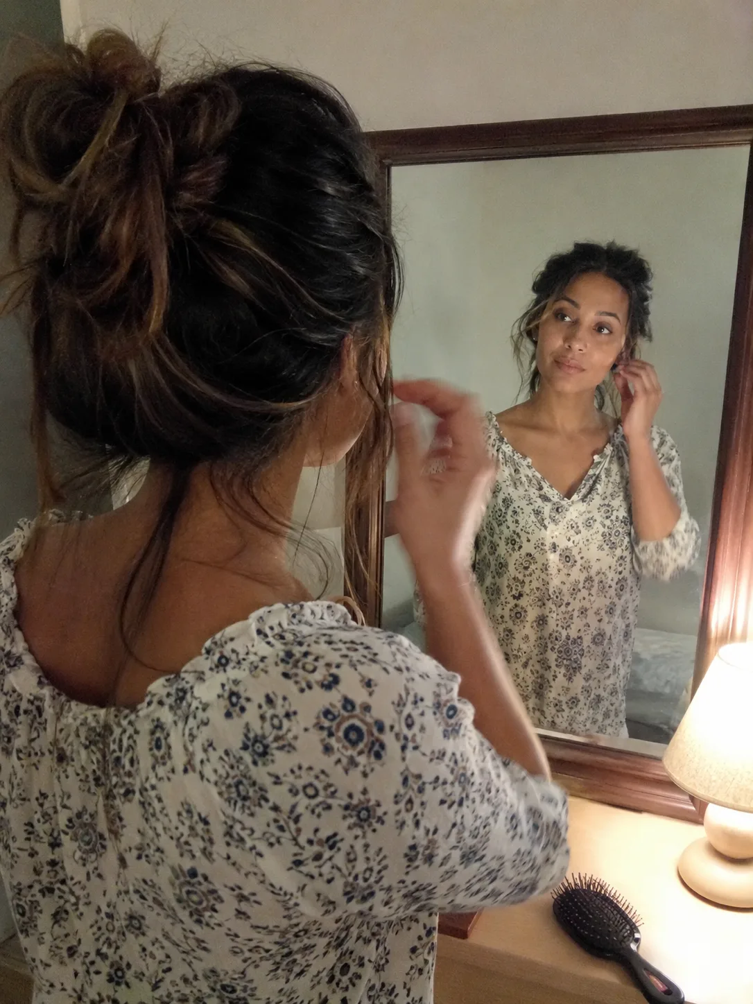 Half up braided beach hairstyle with loose dark waves from the back