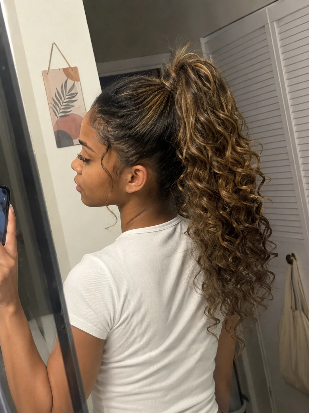 High curled ponytail prom hairstyle for long hair with soft volume.