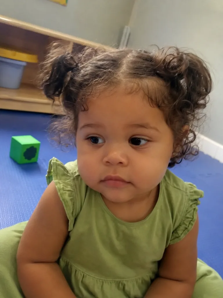 Lightweight and clean styling on fine baby hair showcasing natural texture without heavy buildup.