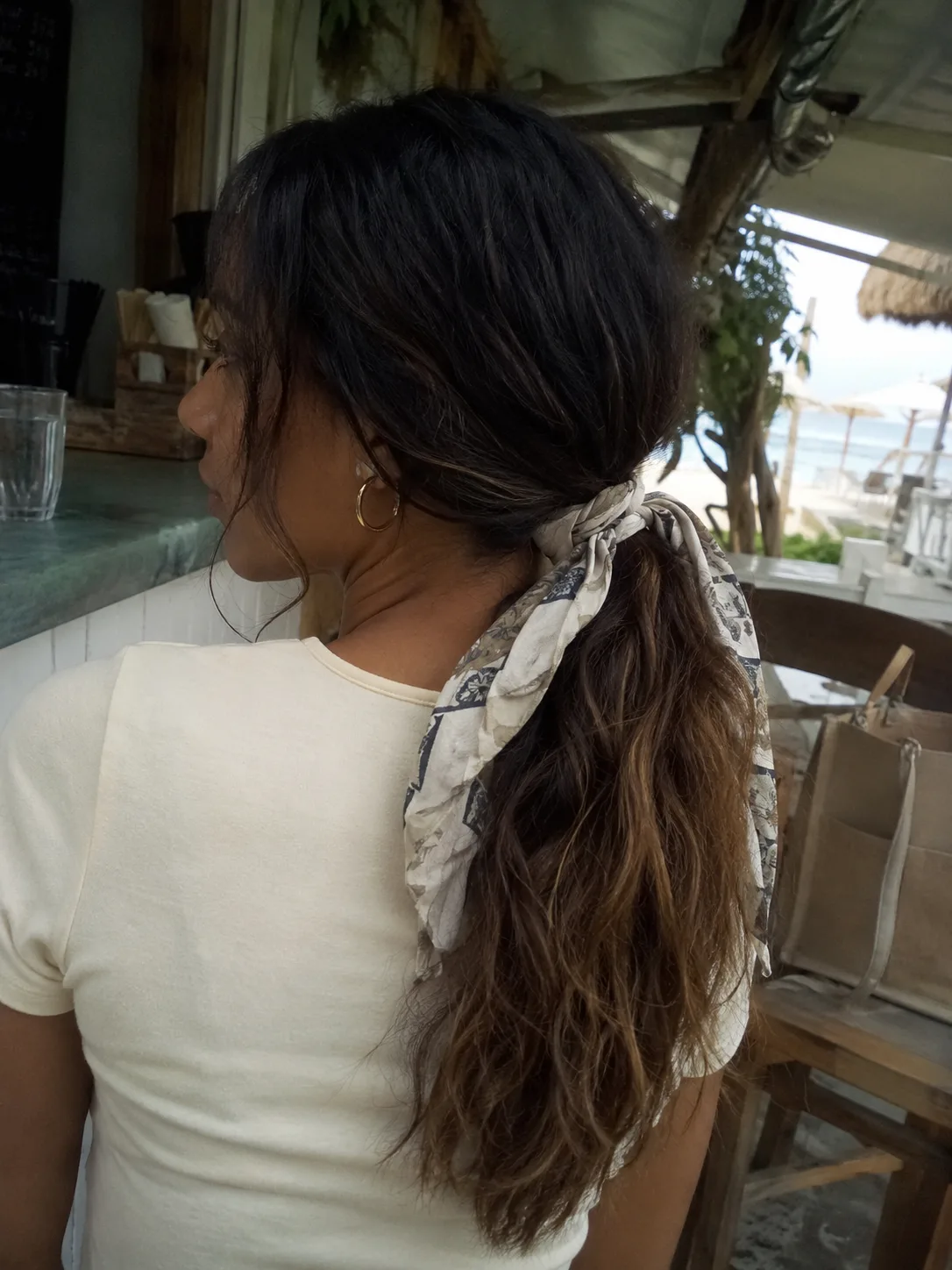 Long beach ponytail tied with a scarf
