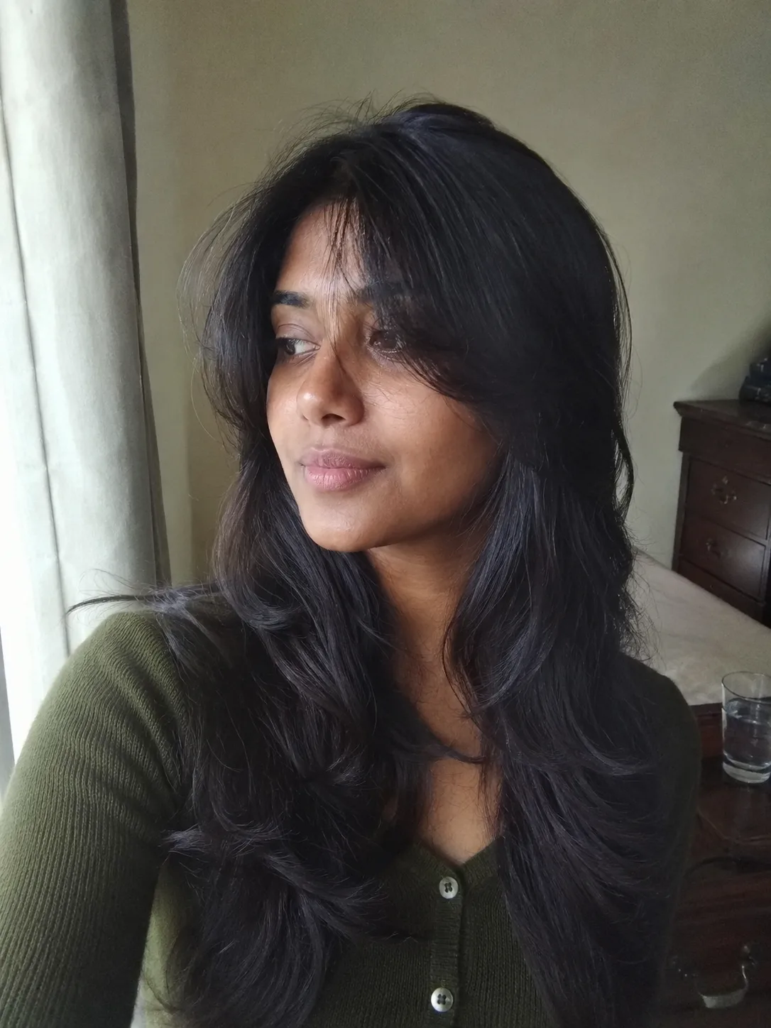 Long blowout hairstyle with soft curtain layers and smooth movement