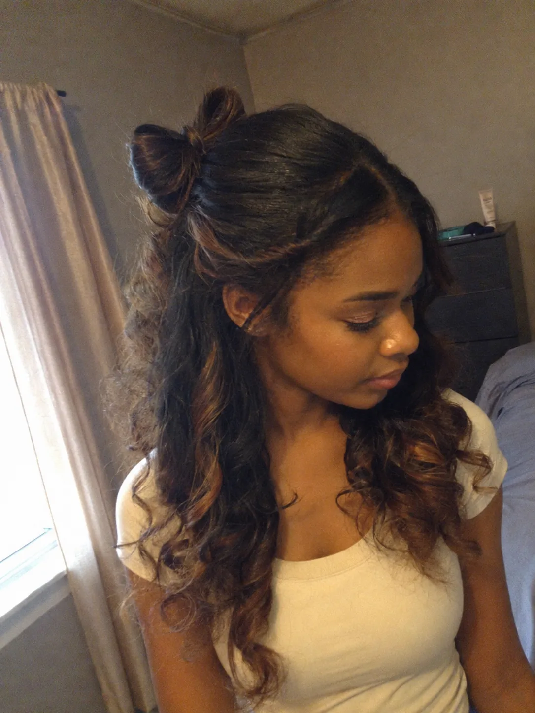 Long curled half-up prom hairstyle with soft face-framing tendrils for black women