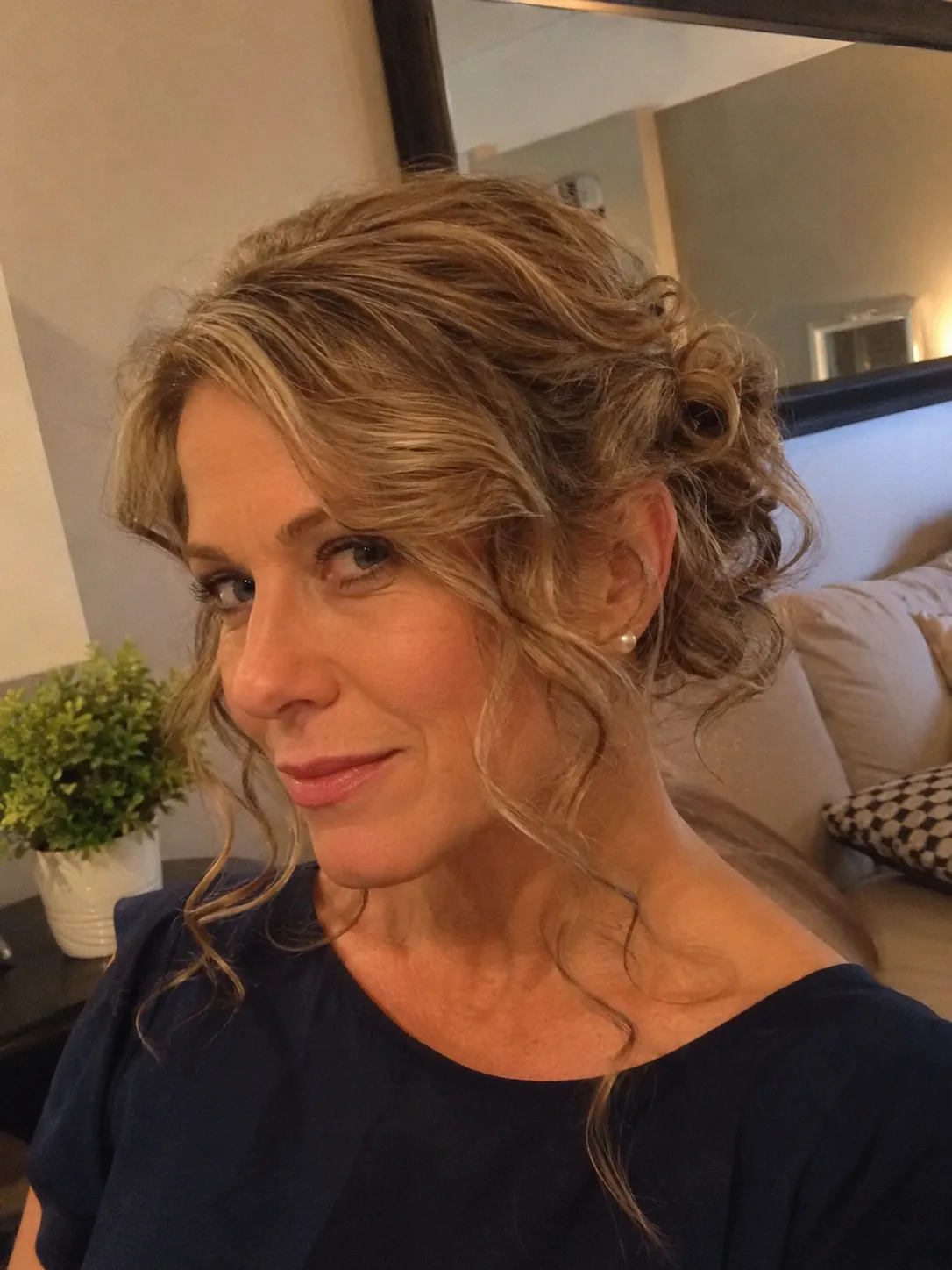 Long hair with multi-directional natural waves styled into a loose, romantic low chignon