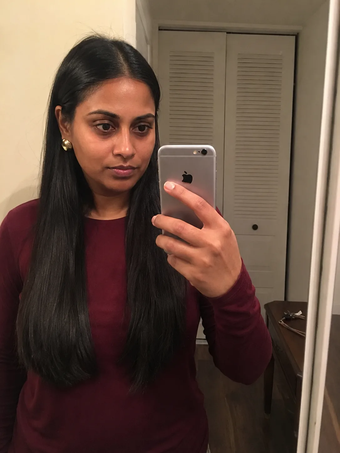 Long, straight, dense dark hair showing natural weight and healthy mid-shaft texture before formal styling