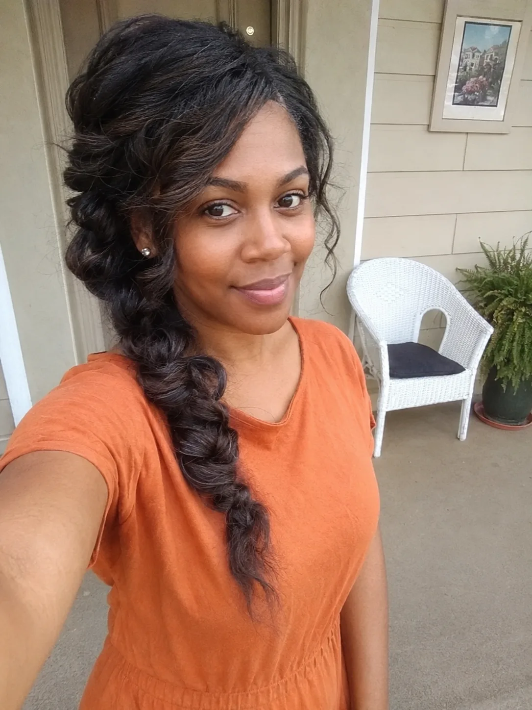 Loose side braid beach hairstyle with soft curls and relaxed outdoor texture.