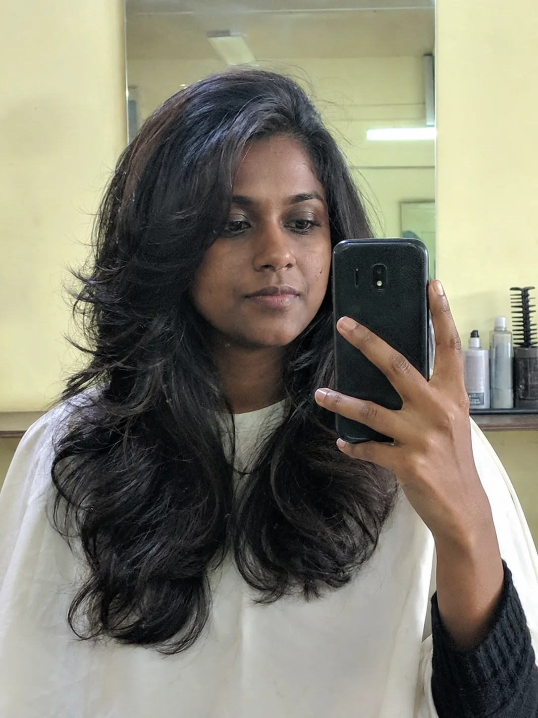 Loose side braid beach hairstyle with soft curls and relaxed texture