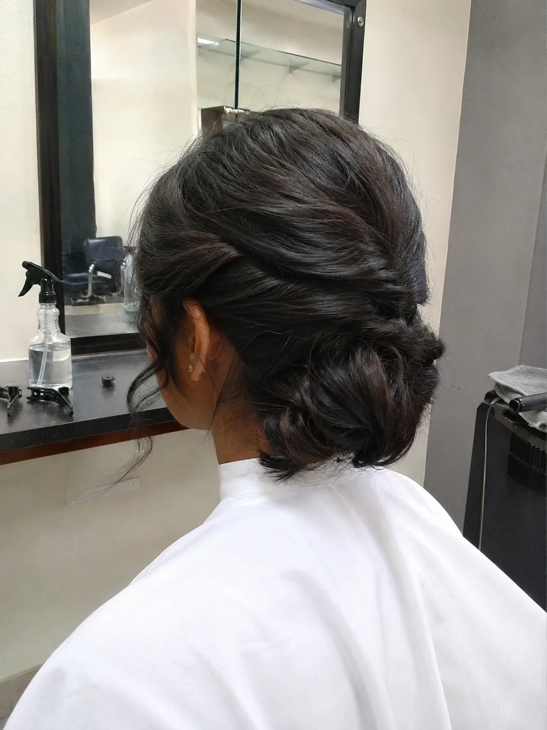 Low chignon prom hairstyle for medium length hair in salon