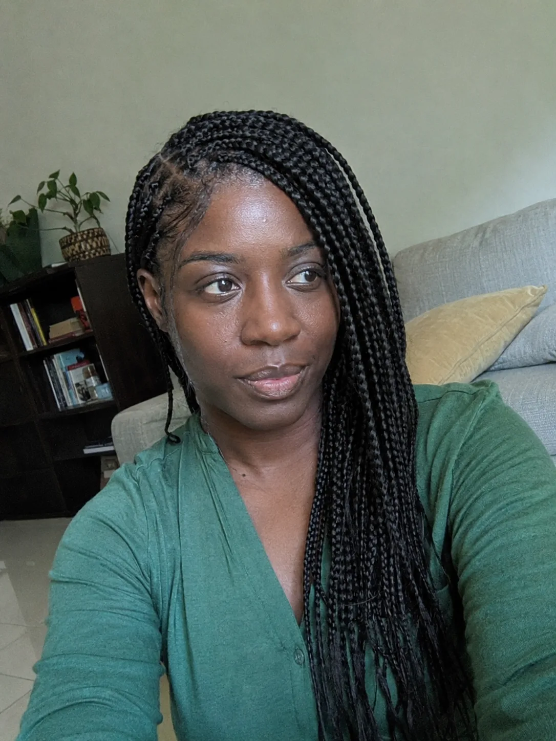 Medium black side part box braids worn over one shoulder