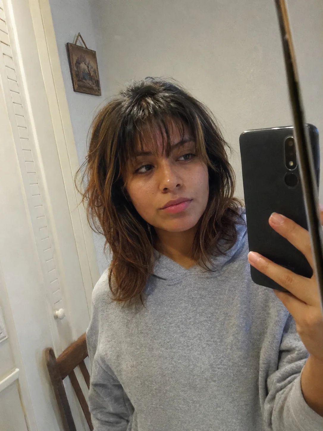 Medium-length wavy hair with curtain bangs and soft layers