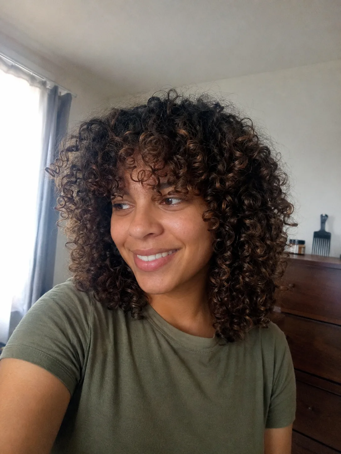 Medium-length wavy hair with curtain bangs and soft layers